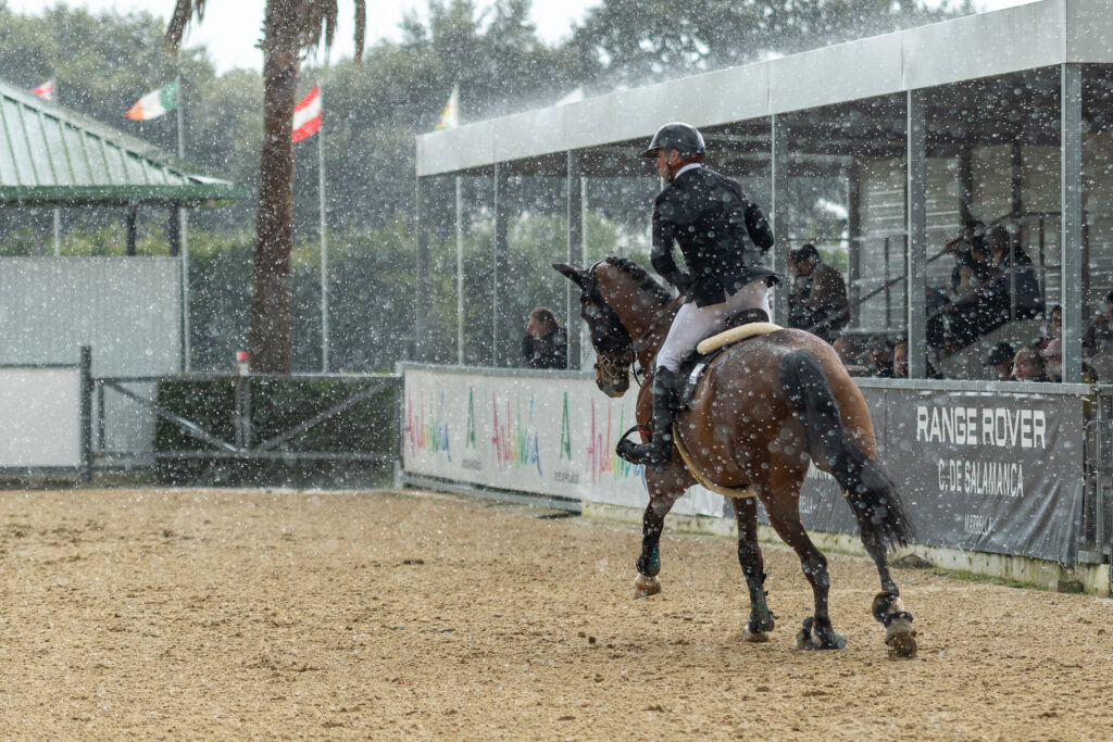 Horse and rider competing in the rain.